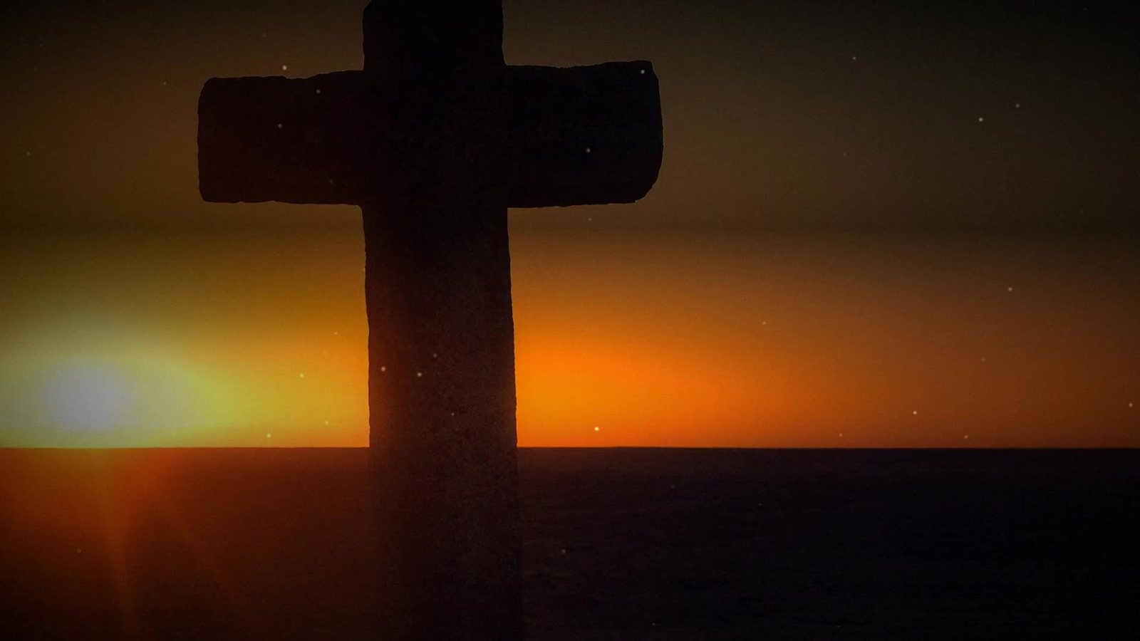 A cross standing against a sunrise over open water — from the Declared Righteous teaser